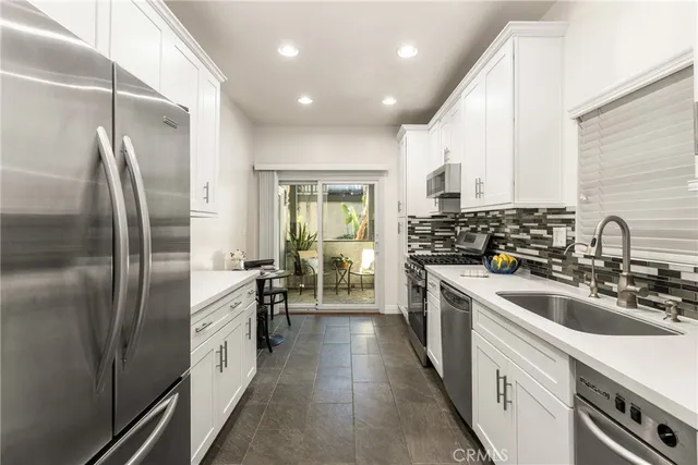 a kitchen with a sink stove and cabinets