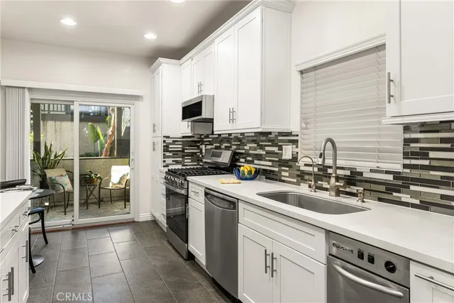 a view of a dining room with furniture and a potted plant
