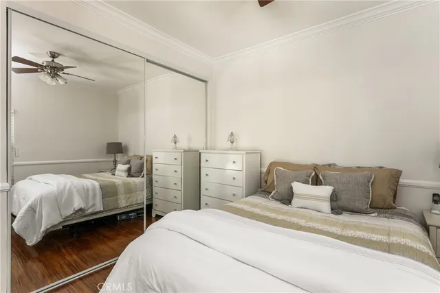 a bedroom with a large bed and a flat tv screen