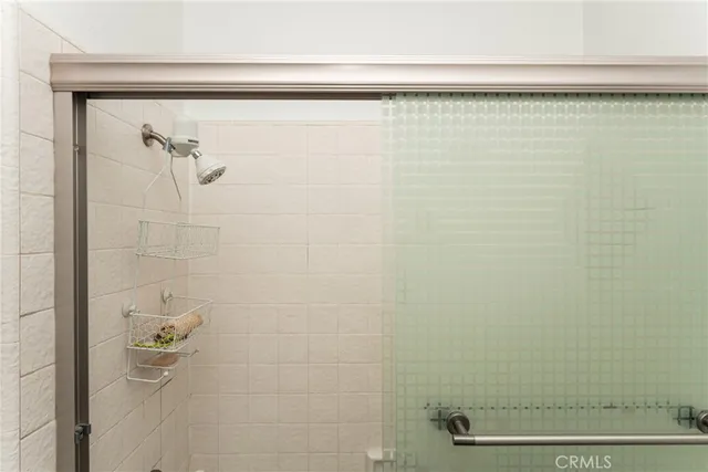 a bedroom with a large bed and a lamp