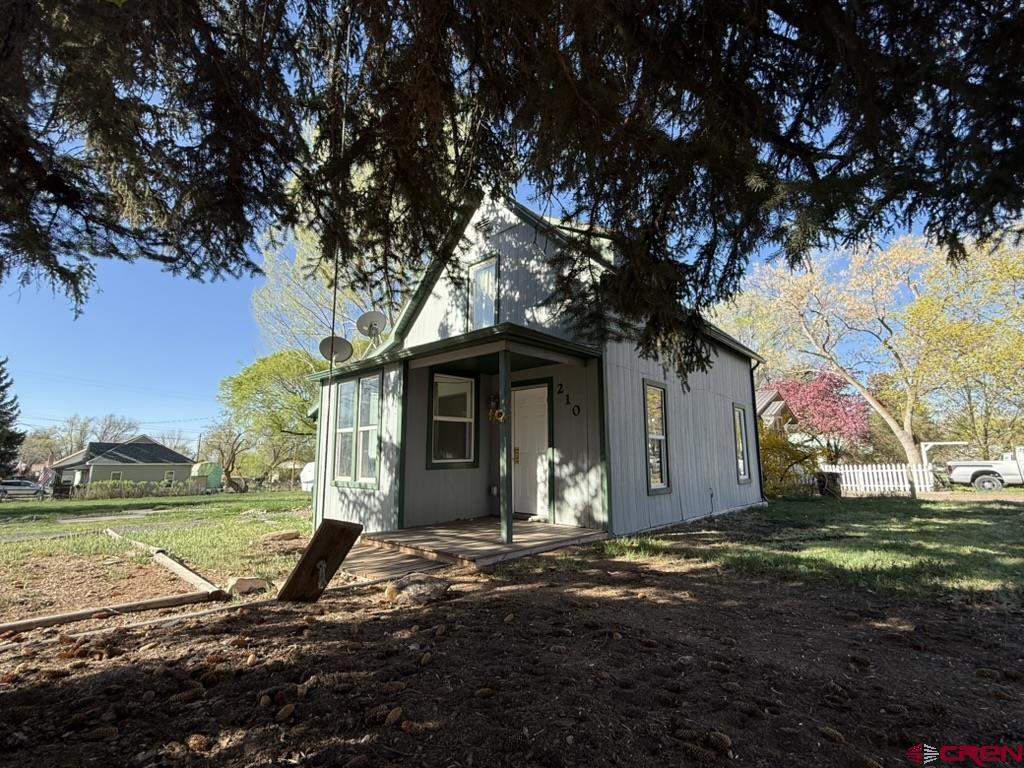 210 Southwest 6th Street Cedaredge, CO 81413 - Photo 16 of 16 a view of a house with a yard