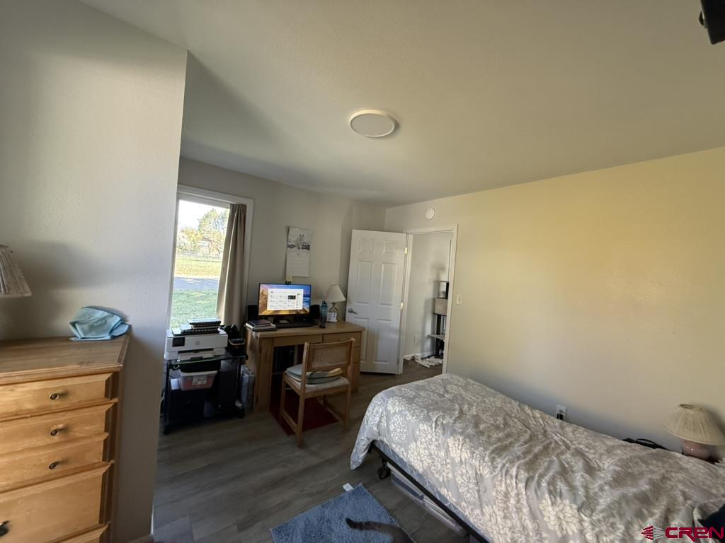 210 Southwest 6th Street Cedaredge, CO 81413 - Photo 5 of 16 a bedroom with a bed and a desk