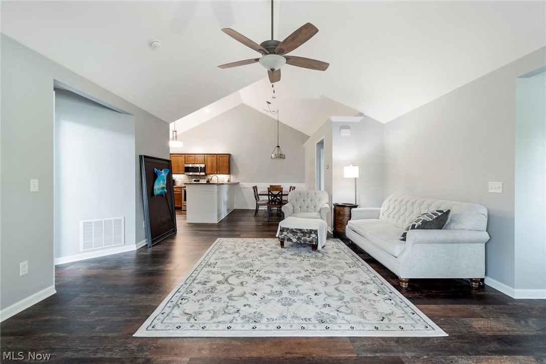 9151 Springfield Road, Unit 1902 Youngstown, OH 44514 - Photo 8 of 36 Living room featuring vaulted ceiling, dark hardwood / wood-style flooring, and ceiling fan