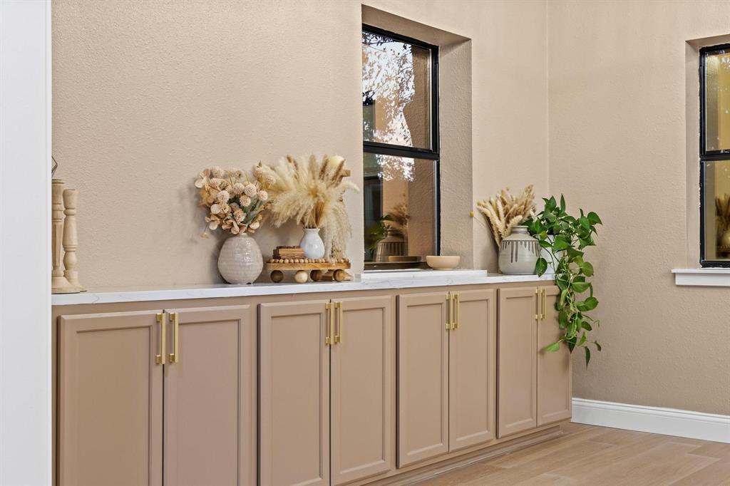 2214 Rex Cruse Drive Sherman, TX 75092 - Photo 14 of 40 a potted plant sitting on a wooden floor