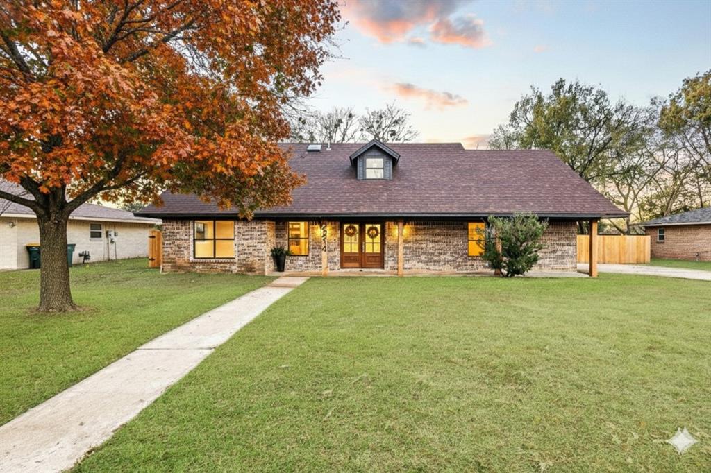 2214 Rex Cruse Drive Sherman, TX 75092 - Photo 2 of 40 a front view of a house with a garden