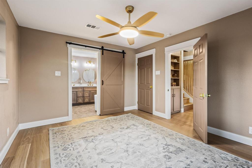 2214 Rex Cruse Drive Sherman, TX 75092 - Photo 23 of 40 wooden floor in a room with a mirror and a ceiling fan