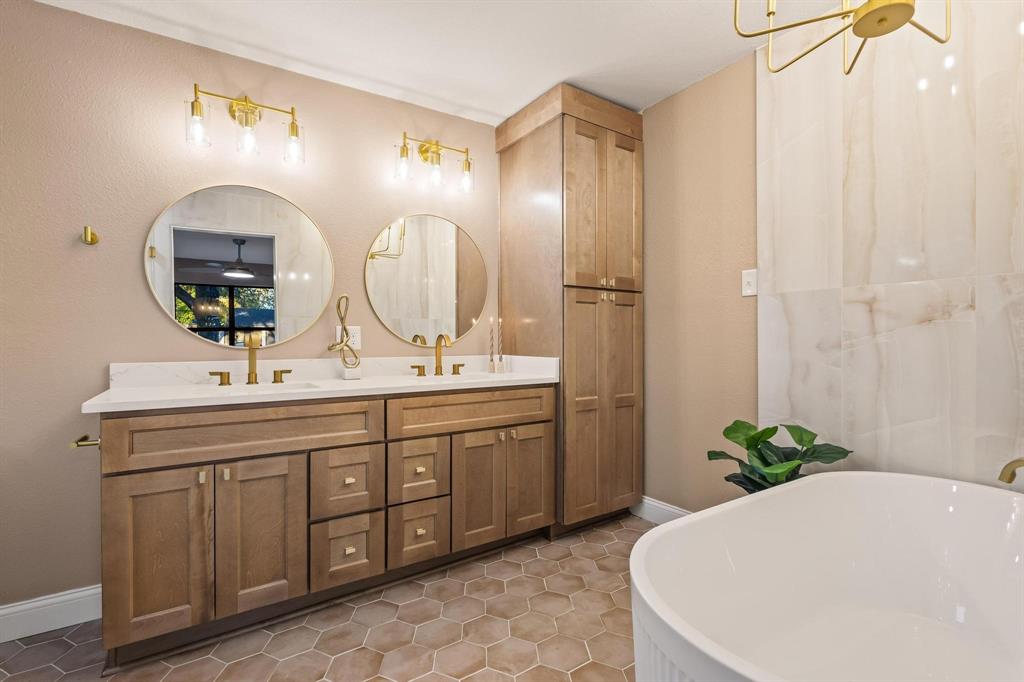 2214 Rex Cruse Drive Sherman, TX 75092 - Photo 25 of 40 a bathroom with a double vanity sink and a mirror