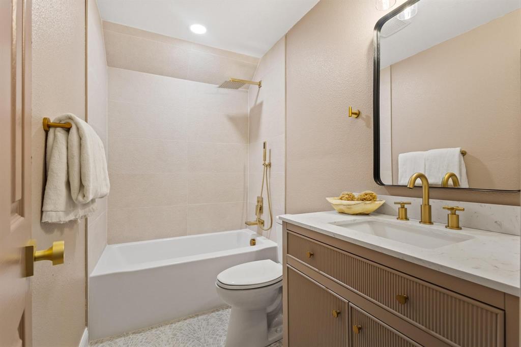 2214 Rex Cruse Drive Sherman, TX 75092 - Photo 33 of 40 a bathroom with a granite countertop sink toilet and shower