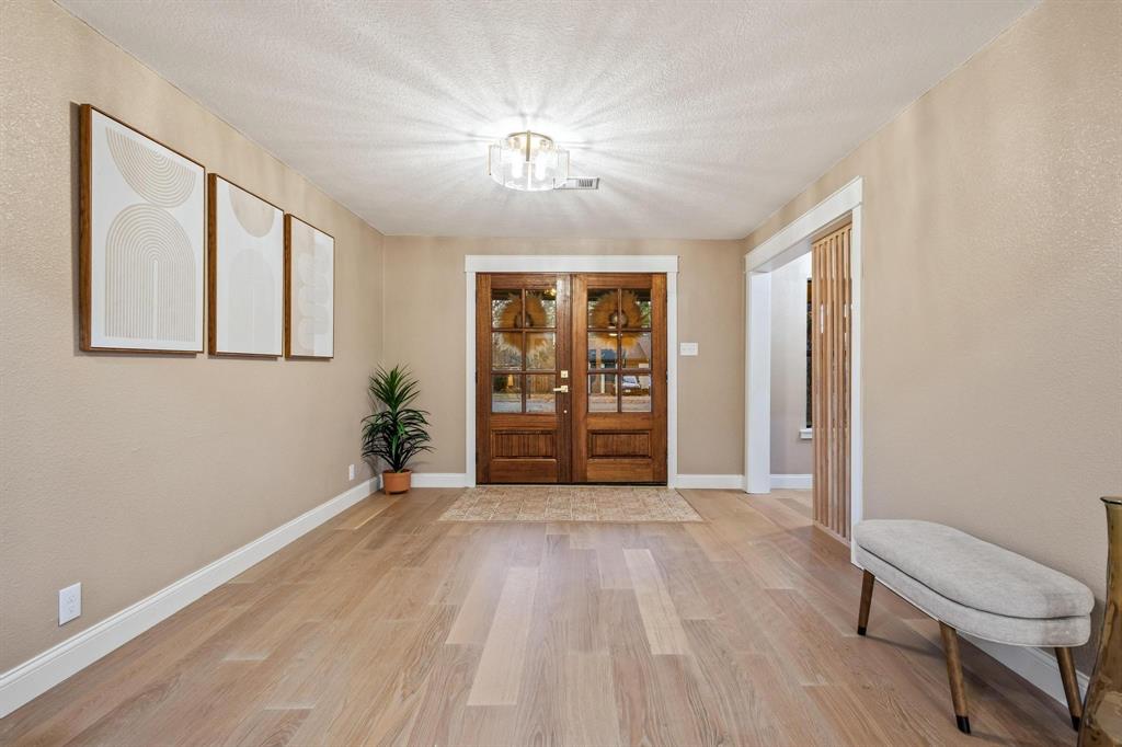 2214 Rex Cruse Drive Sherman, TX 75092 - Photo 4 of 40 a view of an empty room with glass door and a window