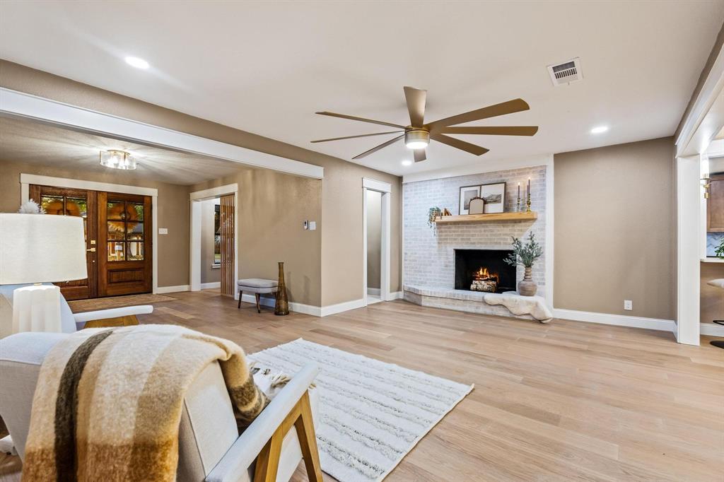 2214 Rex Cruse Drive Sherman, TX 75092 - Photo 6 of 40 a living room with furniture a fireplace and a ceiling fan