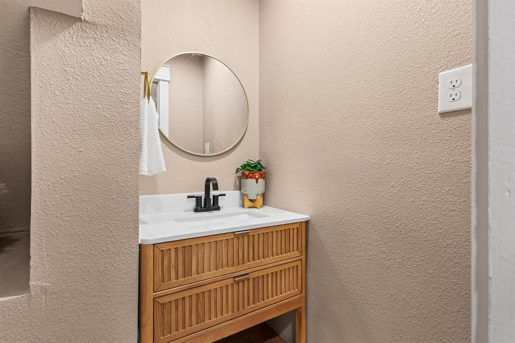 2214 Rex Cruse Drive Sherman, TX 75092 - Photo 8 of 40 a bathroom with a sink and a mirror