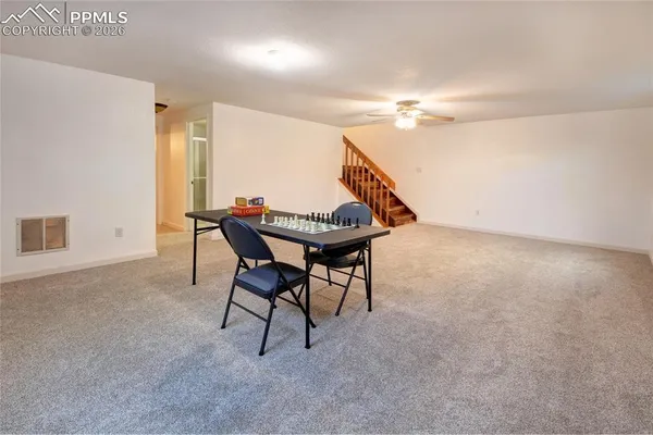 a view of a livingroom with furniture and a ceiling fan