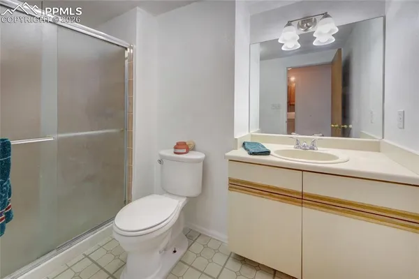 a bathroom with a sink mirror vanity and toilet