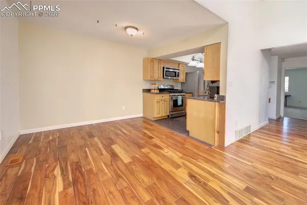 a view of a kitchen from the hallway