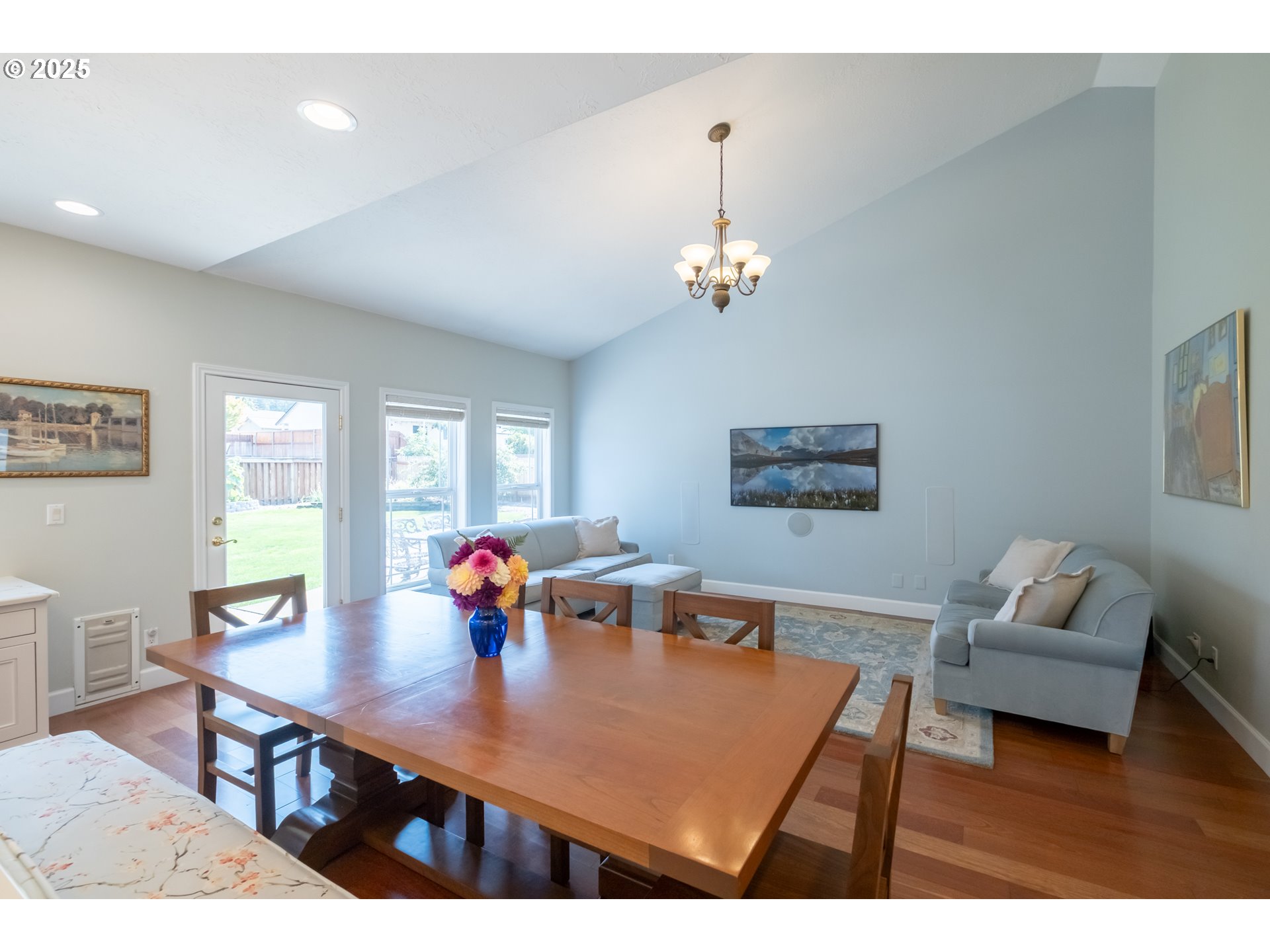 1435 Northwest Ashley Drive Albany, OR 97321 - Photo 15 of 44 a view of a dining room with furniture a chandelier and wooden floor