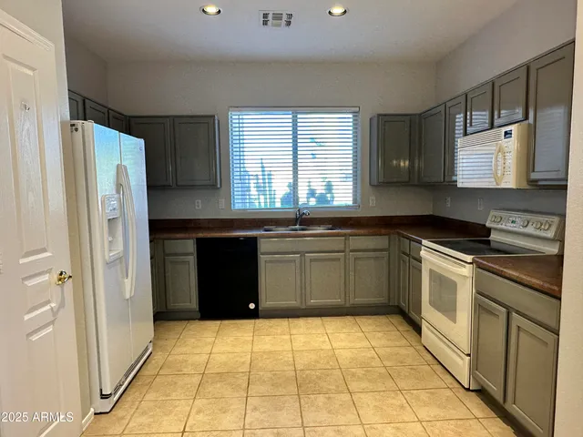 a kitchen with a cabinets and a stove top oven