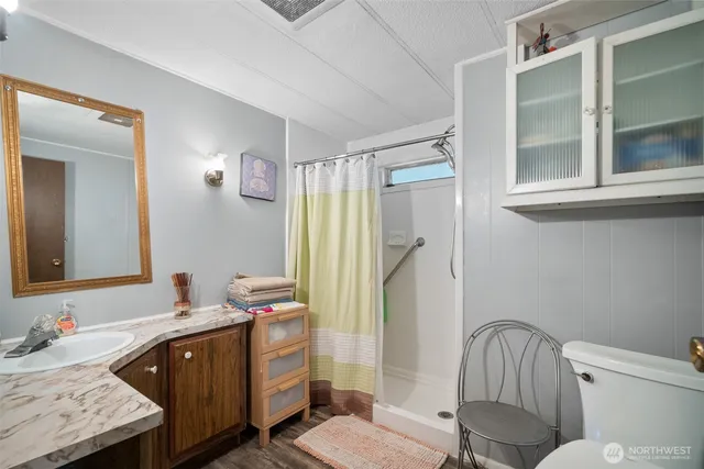 a bathroom with a sink a toilet and a mirror