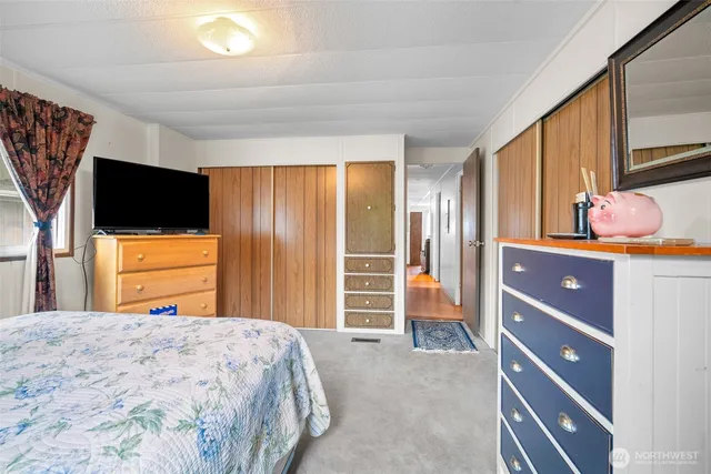 a bedroom with a bed and a flat screen tv