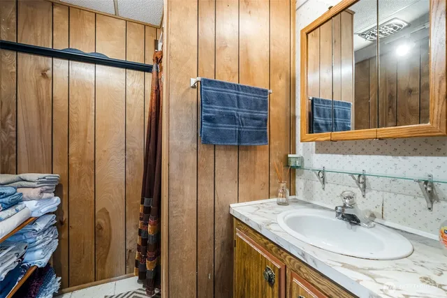 a bathroom with a sink a vanity and a mirror