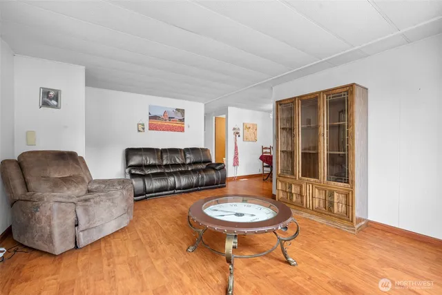 a living room with furniture a table and a large window