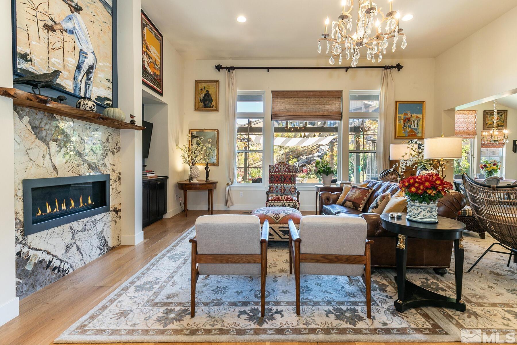 4104 Whispering Pine Loop Reno, NV 89519 - Photo 11 of 27 a living room with furniture a chandelier and a fireplace