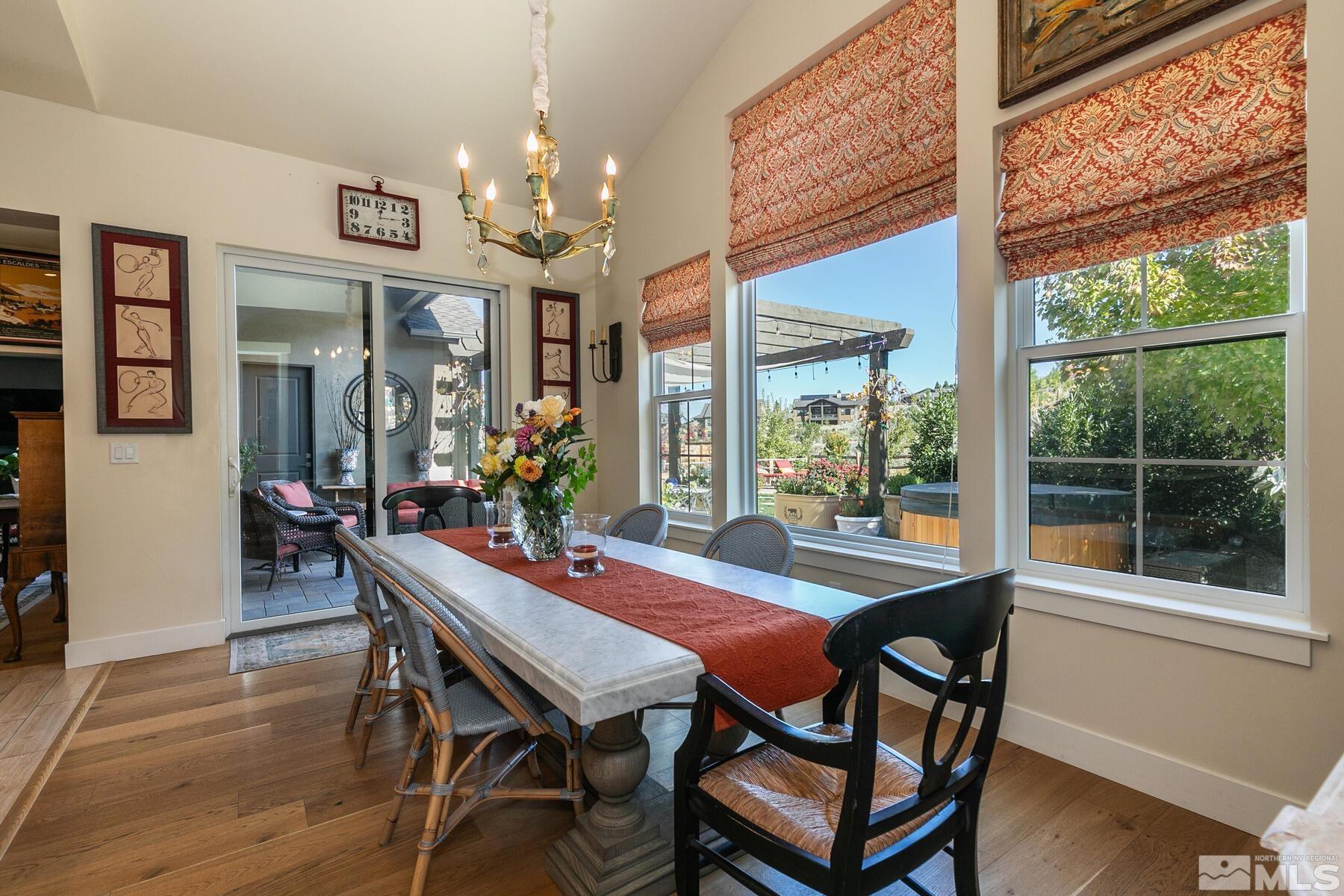 4104 Whispering Pine Loop Reno, NV 89519 - Photo 12 of 27 a view of a dining room with furniture a chandelier and wooden floor
