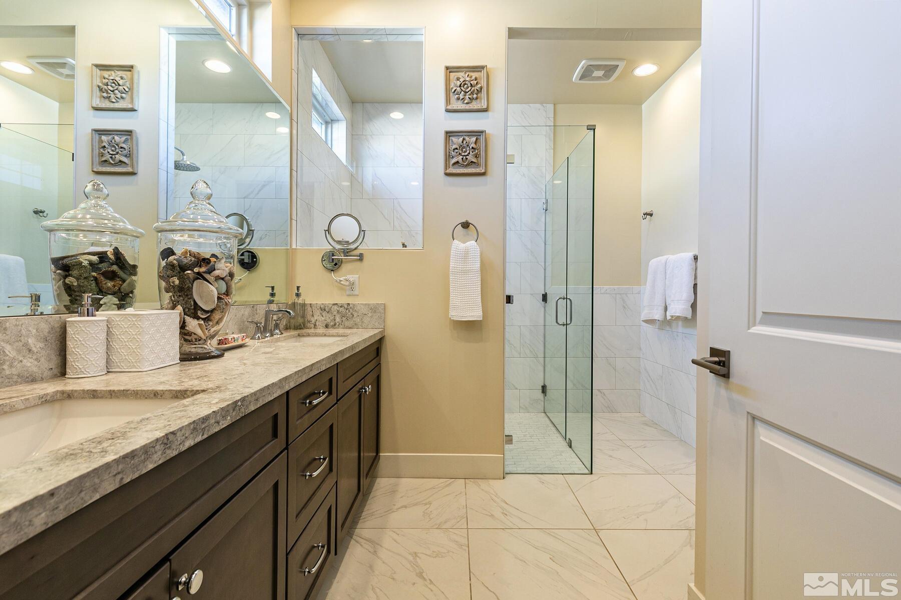 4104 Whispering Pine Loop Reno, NV 89519 - Photo 14 of 27 a bathroom with a granite countertop sink a toilet and shower