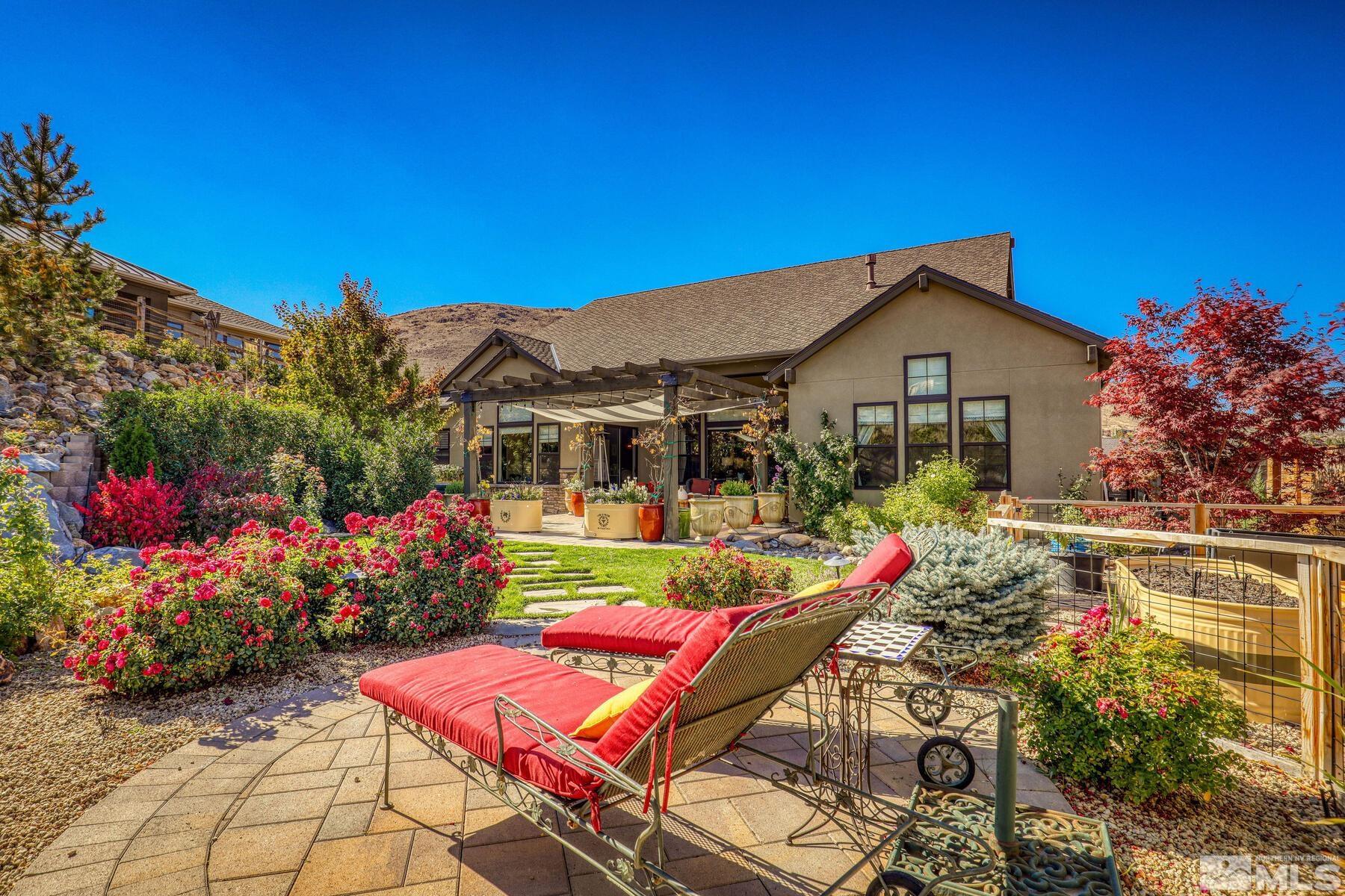 4104 Whispering Pine Loop Reno, NV 89519 - Photo 22 of 27 a view of a house with backyard sitting area and garden