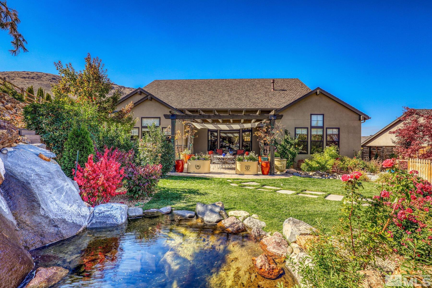 4104 Whispering Pine Loop Reno, NV 89519 - Photo 3 of 27 a front view of a house with garden