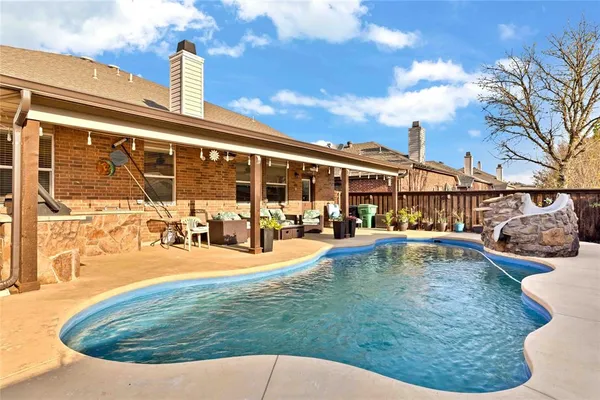 a view of a swimming pool with a patio
