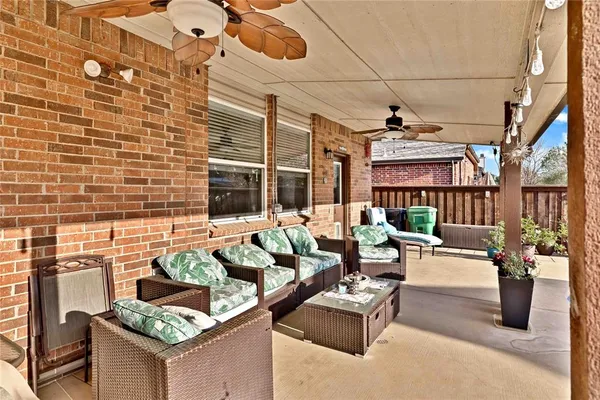 a view of a patio with couches and potted plants
