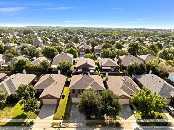 an aerial view of residential houses with outdoor space