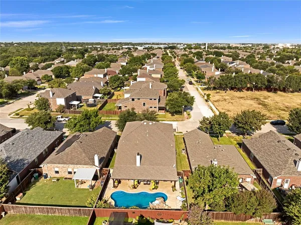 an aerial view of residential houses with outdoor space