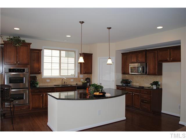 1009 Bianco Drive Raleigh, NC 27607 - Photo 2 of 12 a living room with stainless steel appliances kitchen island granite countertop a sink a refrigerator and a cabinets