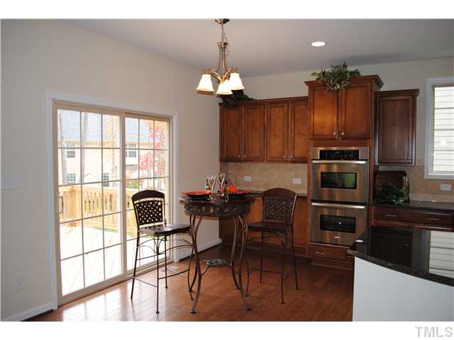 1009 Bianco Drive Raleigh, NC 27607 - Photo 3 of 12 a kitchen with a refrigerator and a stove