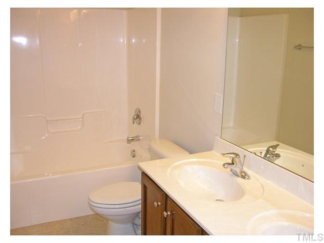 1009 Bianco Drive Raleigh, NC 27607 - Photo 10 of 12 a bathroom with a sink toilet vanity and shower