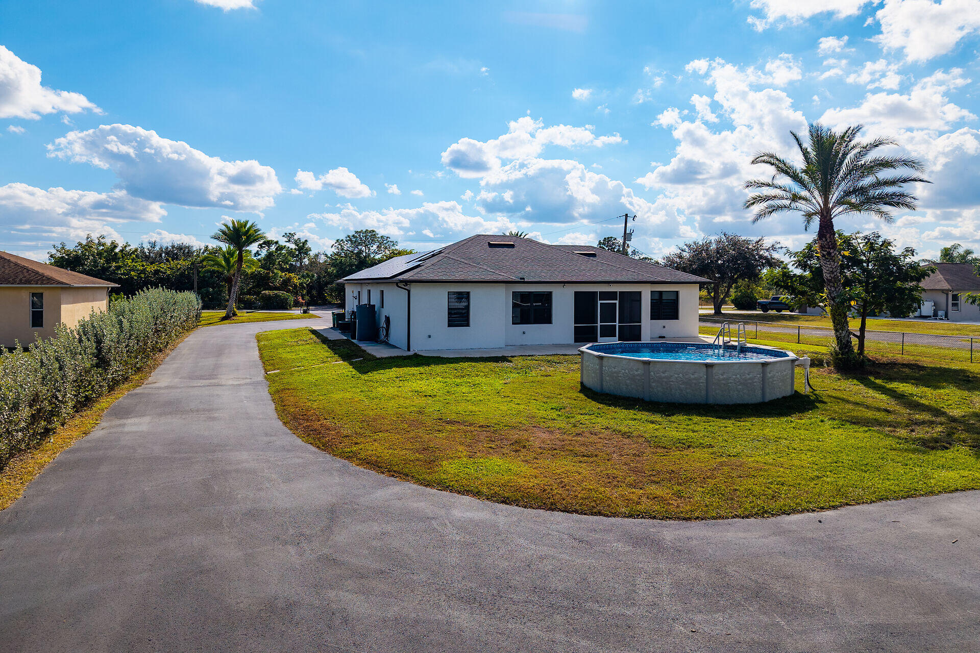 3625 54th Avenue Northeast Naples, FL 34120 - Photo 24 of 40 a view of a house with swimming pool and a yard