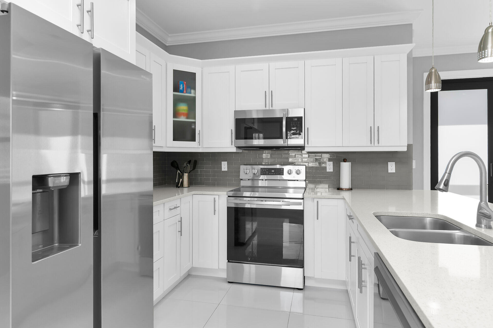 3625 54th Avenue Northeast Naples, FL 34120 - Photo 10 of 40 a kitchen with stainless steel appliances granite countertop a refrigerator stove and sink