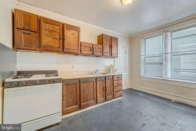 a kitchen with stainless steel appliances granite countertop a stove and a sink