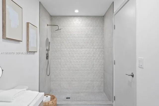 a bathroom with a double vanity sink toilet mirror and shower