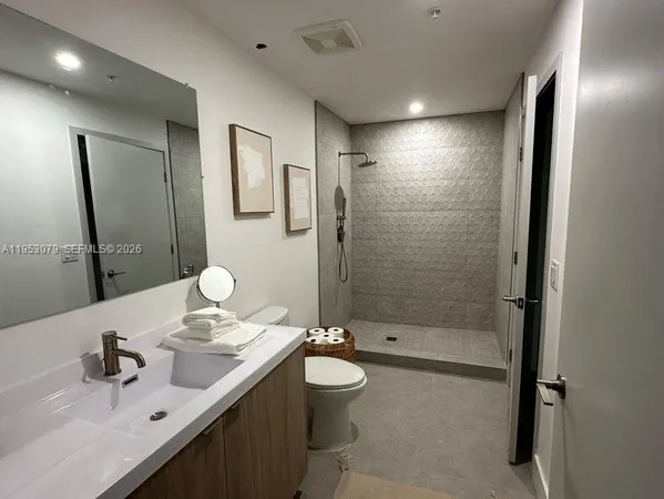 a room with pool table and windows