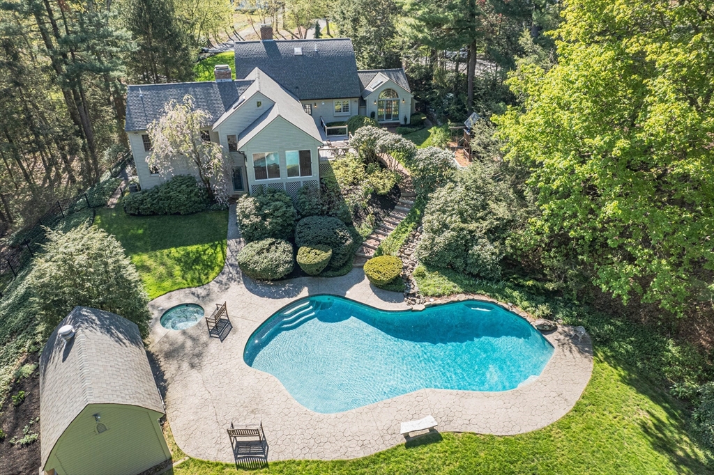 an aerial view of a house with garden space sitting space and swimming pool