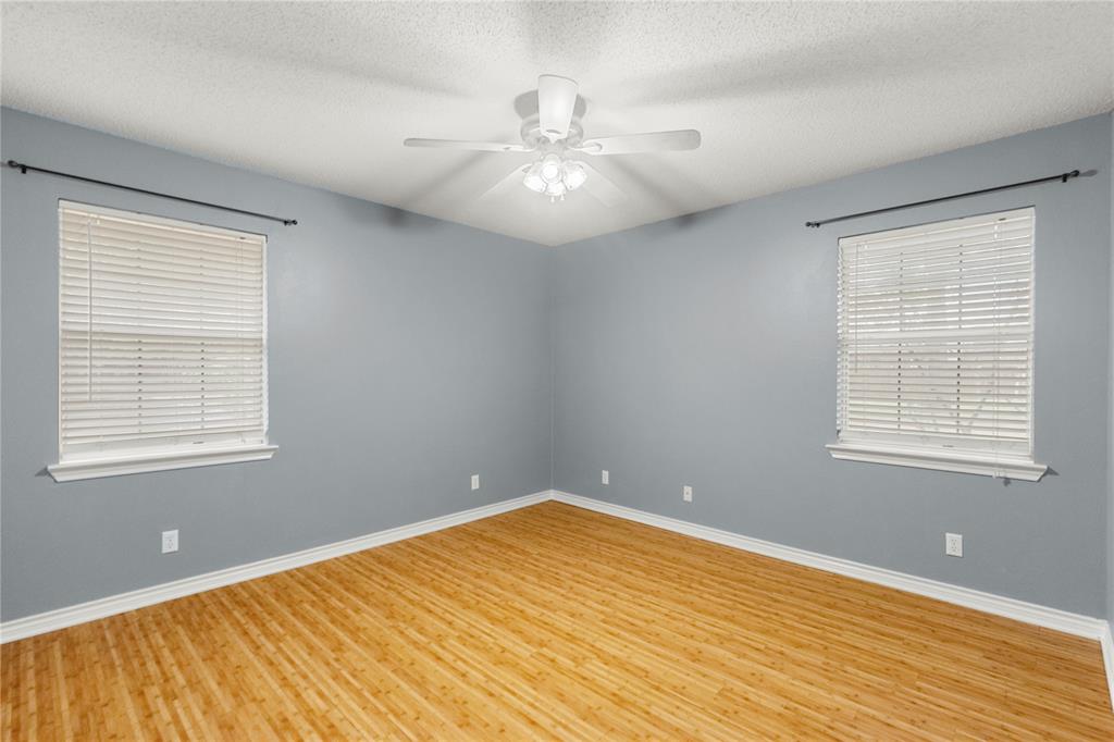 2917 Harlow Road Commerce, TX 75428 - Photo 25 of 40 a view of an empty room with wooden floor and a window