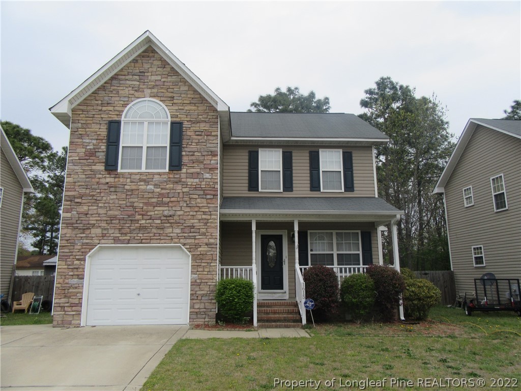 1615 Silver Ridge Court Fayetteville, NC 28304 - Photo 1 of 27 a front view of a house with a garden and plants