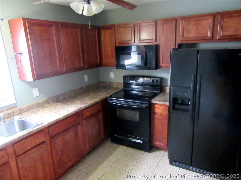 1615 Silver Ridge Court Fayetteville, NC 28304 - Photo 12 of 27 a kitchen with granite countertop a refrigerator stove and microwave