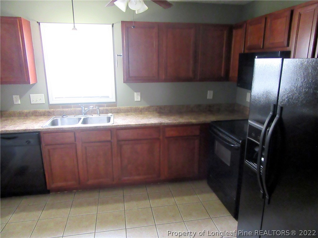 1615 Silver Ridge Court Fayetteville, NC 28304 - Photo 13 of 27 a kitchen with a sink a refrigerator and window
