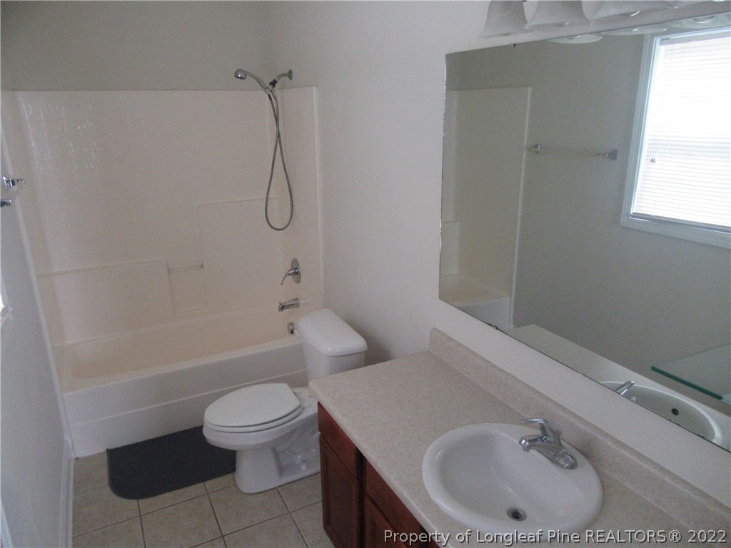 1615 Silver Ridge Court Fayetteville, NC 28304 - Photo 20 of 27 a bathroom with a sink a toilet and a bathtub
