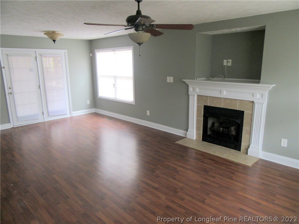 1615 Silver Ridge Court Fayetteville, NC 28304 - Photo 8 of 27 a view of an empty room with wooden floor and a fireplace