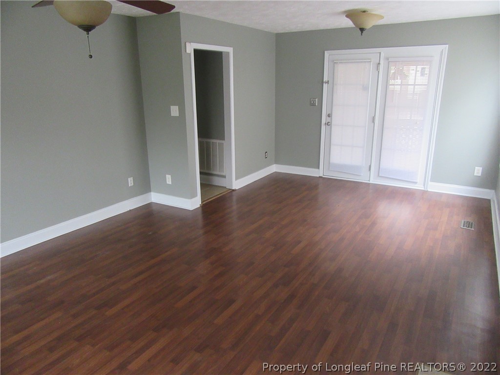 1615 Silver Ridge Court Fayetteville, NC 28304 - Photo 10 of 27 an empty room with wooden floor and windows