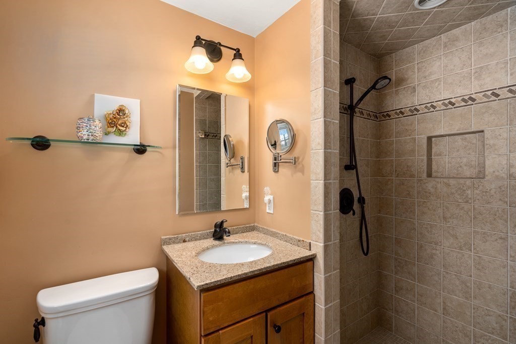 110 Victoria Road Sudbury, MA 01776 - Photo 17 of 25 a bathroom with a granite countertop sink toilet and shower